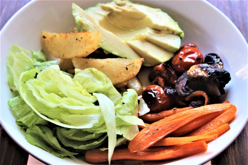 Seasonal fruit and greens salad with avocado