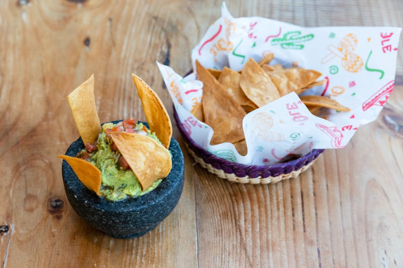 Fresh guacamole and chips with lime